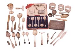 A mixed lot of flatware, wine labels and a cigarette case; including an early Georg Jensen gilt spoo
