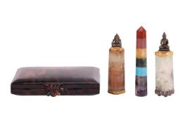 A tortoiseshell vanity case with compartments and a comb, together with two quartz talismans and a s