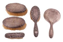 Five silver mounted dressing table accrouments, including a hand mirror, a pair of hair brushes, a f
