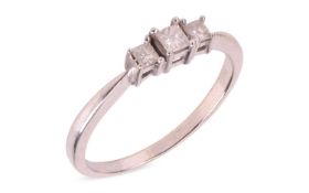 A three-stone diamond ring; claw-set with three graduated princess-cut diamonds, the largest to the 