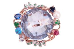 A gem-set cocktail ring, centrally set with a rose-cut synthetic spinel, in a foliate-inspired surro