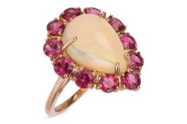 An opal and rubellite cluster ring in 9ct gold, centred with a teardrop-shaped Ethiopian opal caboch