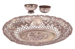A German white metal sweetmeat dish, oval, the central with a chase scene of putti gambolling amongs