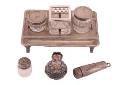 A George III silver ink stand, rounded rectangular with reeded borders and two glass bottles (one a 