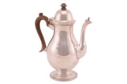 A silver coffee pot in George III style; baluster form with domed, hinged cover and panelled spout w