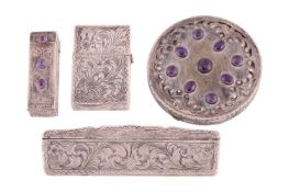 A set of continental dressing table items, with scroll and floral engraving, including a comb, a lig