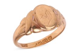 A signet ring in 18ct yellow gold, the oval head engraved with a monogram, between shoulders in cros