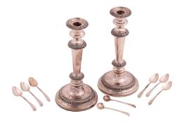 A pair of 19th century Old Sheffield Plate candlesticks, circular with tapering cylindrical stems an