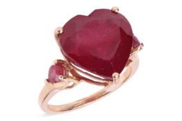 A ruby ring, the heart-shaped glass-filled ruby, flanked by pear-shaped rubies, mounted in 9ct yello