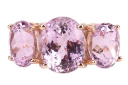 A three-stone kunzite ring in 9ct gold, comprising three graduated oval-cut kunzites in claw mounts,