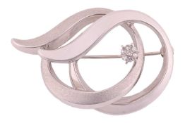A diamond-set brooch in 18ct white gold, of abstract sinuous form, partially with matte finish, diam