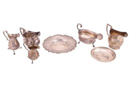 A small collection of silver items, comprising four creamers of various designs, including one Georg