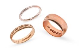 A 9 carat gold ring, 1.6 grams; a 9 carat rose gold ring 4.3 grams; and a white metal band marked pl