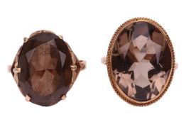 Two smoky quartz rings; both set with oval-cut gemstones, one in foliate mount, yellow metal stamped