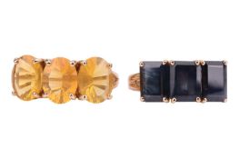 A pair of gem-set rings, the first claw-set with three oval-shaped fire opals, the second claw-set w