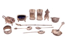 A small group of silver items comprising a pair of octagonal pepperettes, cruets set with blue glass