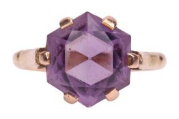 An amethyst dress ring, the hexagonal-cut amethyst in a claw setting between chenier shoulders, with