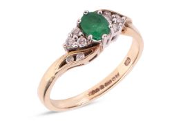 An emerald and diamond dress ring in 9ct gold, centred with an oval-cut emerald of 4.9 x 4.0 x 2.5mm