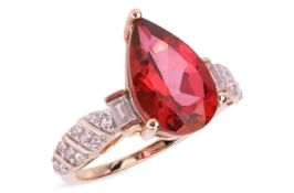 A mystic red topaz and colourless topaz ring, the pear-shaped coated topaz, flanked by a single bagu