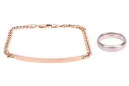 A 9ct yellow gold ID bracelet, composed of a curved bar, flanked by flat curb links, to a lobster cl