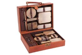 A cased silver-mounted dressing table set, by The Goldsmiths and Silversmiths Co. Ltd., London 1950,