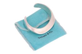 Tiffany & Co. - a 'Swirl cuff' by Elsa Peretti, of hollow abstract form, signed and stamped '925