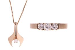 A diamond set pendant necklace and a CZ trilogy ring; the pendant set with a round brilliant cut dia