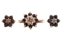 A sapphire and diamond cluster ring and a pair of matching earrings, each with a central round brill