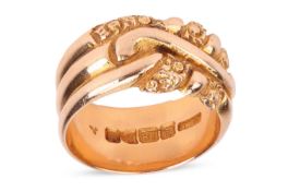 An Edwardian wide band ring in 18ct gold, the fluted band engraved with floral patterns to the front