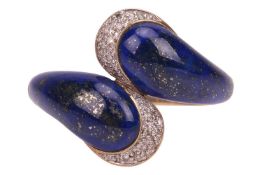 A lapis lazuli crossover ring in 9ct gold, the bypass band terminated with polished lapis lazuli and