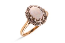An opal and diamond cluster ring in 18ct gold, the oval ring head centred with an opal cabochon of 7