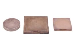 Three silver compacts; the first square compact with engine-turned cover and bevelled mirror, London