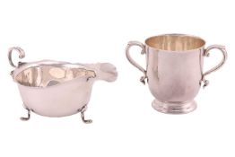 A silver twin-handled cup on stepped foot, by William Hutton & Sons Ltd, Birmingham 1922; and a 