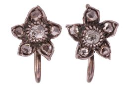 A pair of floral cluster earrings, each earring featuring a central old-cut diamond encircled by fiv