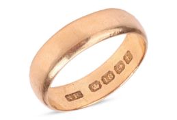 A wide wedding band in 18ct yellow gold, the polished D-profile band bearing Birmingham assay marks,