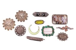 A small collection of white metal brooches; to include examples of a Norwegian enamel crescent brooc
