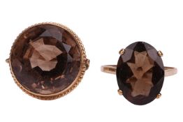 Two smoky quartz rings; the first contains a circular-cut smoky quartz, in a beaded mount in unmarke