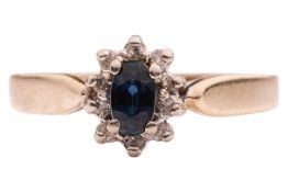 A sapphire and diamond cluster ring, the oval-shaped sapphire, weighing approximately 0.35ct, within