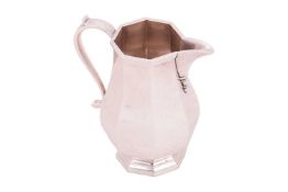 A silver octagonal cream jug, by Asprey & Co., London 1978, faceted baluster body on stepped oct