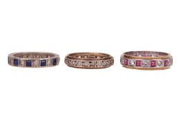 Three gem-set rings; The first a blue sapphire and synthetic colourless sapphire eternity ring in wh