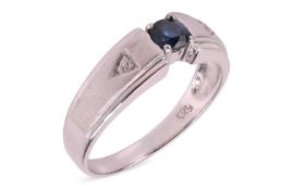 A sapphire and diamond three-stone ring, the central four-claw set circular-cut sapphire, flanked by