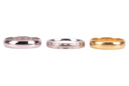 Three gold wedding bands; two in 18ct gold, 7.4 grams; and one in 9ct gold, 2.3 grams. (3)
