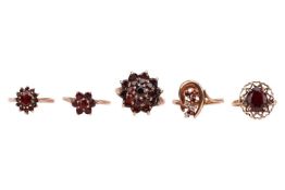 A small group of garnet-set dress rings, including two floral cluster rings, sizes P and Q1/2, a gar