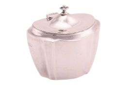 A silver sugar box, of ‘Chippendale’ shaped, with a hinged dome cover and an urn-shaped finial, bear