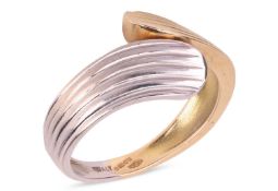 A two-toned bypass ring in 18ct gold, of tapered groove design, London 2002, sponsor’s mark ‘GA’, si