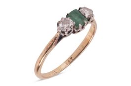 An emerald and diamond trilogy ring, featuring a central claw-set emerald-cut emerald of yellowish-g