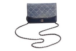 Chanel - a ‘Gabrielle’ wallet on chain in blue printed denim and navy calfskin leather, with a magne