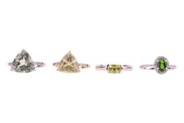 Four green gem-set rings; to include, a chrome diopside ring, within a cz halo and with cz set shoul
