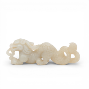 China, a pale jade brushrest shaped as a dragon, probably late Ming- early Qing dynasty,