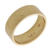A dress ring, the polished band with screwhead motifs, stamped '18K', ring size I. ...